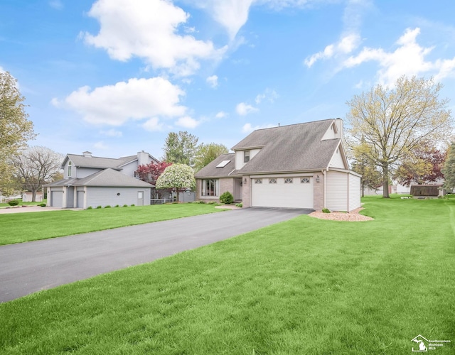 view of front of home with a front lawn, driveway, brick siding, and an attached garage