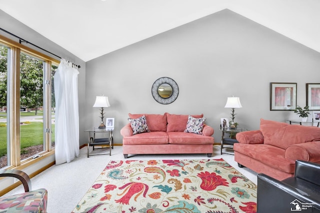 carpeted living room with vaulted ceiling and baseboards
