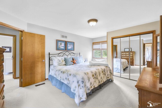 carpeted bedroom with a closet