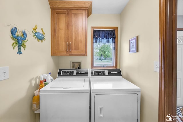 laundry room featuring cabinet space and separate washer and dryer