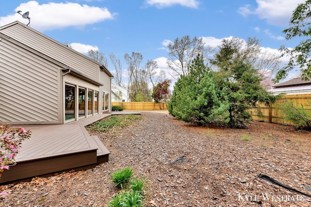 view of yard featuring a wooden deck and a fenced backyard