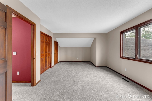 bonus room with carpet floors, baseboards, and visible vents