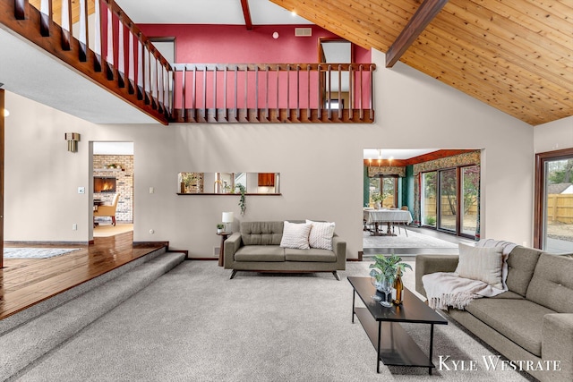 living area featuring high vaulted ceiling, visible vents, beamed ceiling, carpet floors, and a notable chandelier