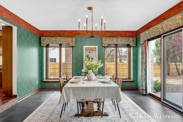 dining space featuring a notable chandelier, baseboards, and wallpapered walls