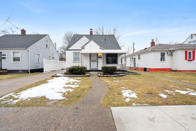 bungalow-style house with a porch and a chimney
