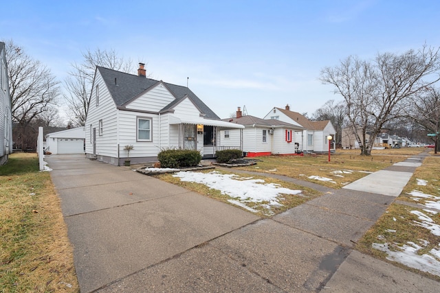 bungalow-style house with an outdoor structure, a detached garage, and a porch