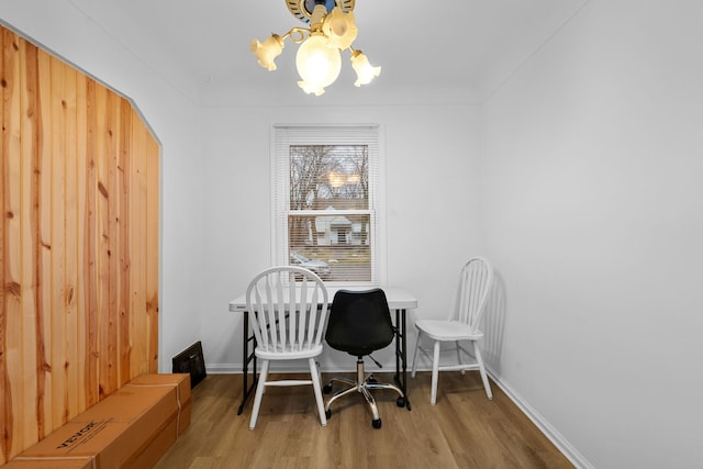 office space featuring a chandelier, wood finished floors, and baseboards
