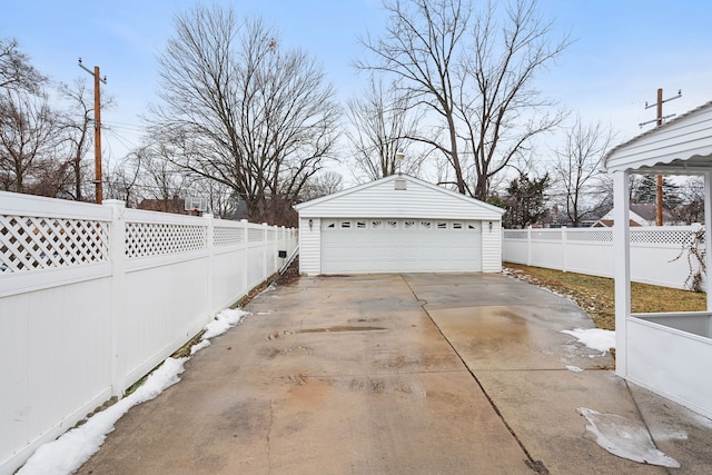detached garage featuring fence