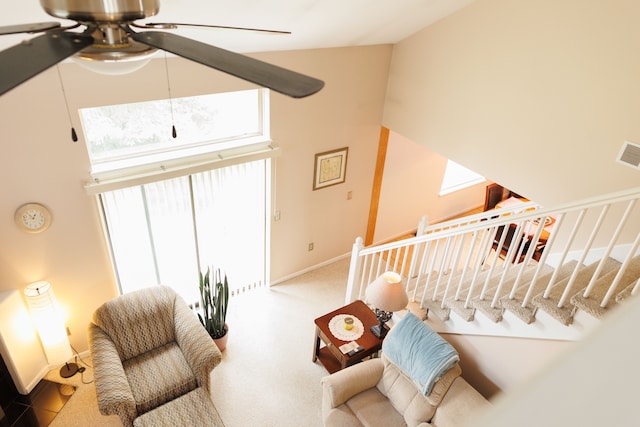 living room with high vaulted ceiling, baseboards, and a ceiling fan