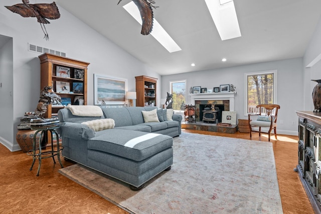 3370 Breezewood, Ortonville, MI 48462 - living area featuring a tiled fireplace, a skylight, vaulted ceiling, recessed lighting, and baseboards