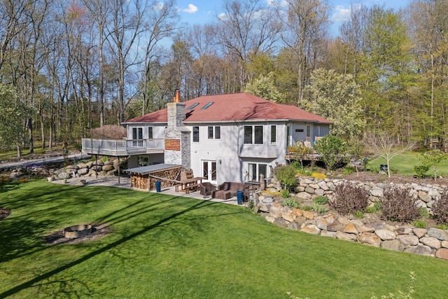 3370 Breezewood, Ortonville, MI 48462 - back of property with french doors, an outdoor fire pit, a patio area, a chimney, and a deck