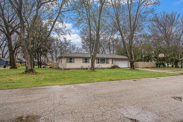 2737 Patricia Dr, Muskegon, MI 49445 - view of front facade featuring a front lawn, an attached garage, and driveway