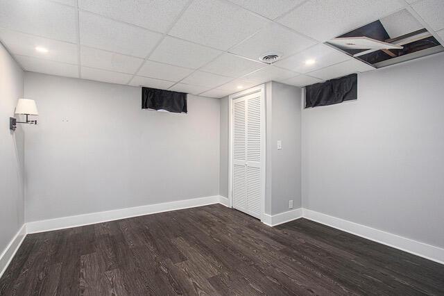 2737 Patricia Dr, Muskegon, MI 49445 - finished basement with dark wood finished floors and a paneled ceiling