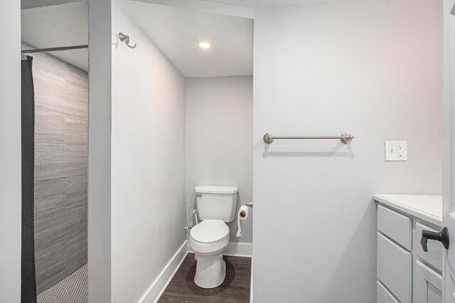 2737 Patricia Dr, Muskegon, MI 49445 - full bathroom with a tile shower, vanity, and wood finished floors