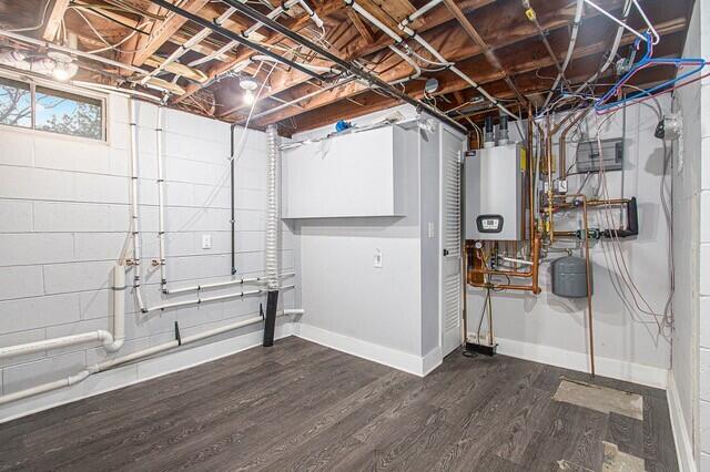 2737 Patricia Dr, Muskegon, MI 49445 - basement featuring water heater, dark wood-style flooring, and concrete block wall