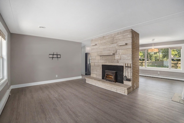 2737 Patricia Dr, Muskegon, MI 49445 - unfurnished living room with a baseboard heating unit and wood finished floors