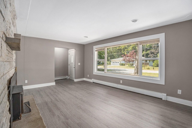 2737 Patricia Dr, Muskegon, MI 49445 - unfurnished living room with baseboard heating and wood finished floors