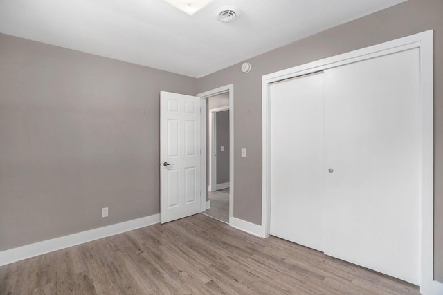 2737 Patricia Dr, Muskegon, MI 49445 - unfurnished bedroom with light wood-style floors and a closet