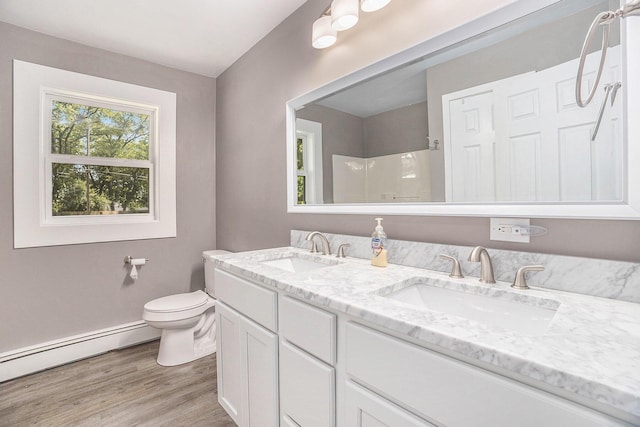 2737 Patricia Dr, Muskegon, MI 49445 - full bathroom featuring double vanity, a baseboard heating unit, wood finished floors, and a shower