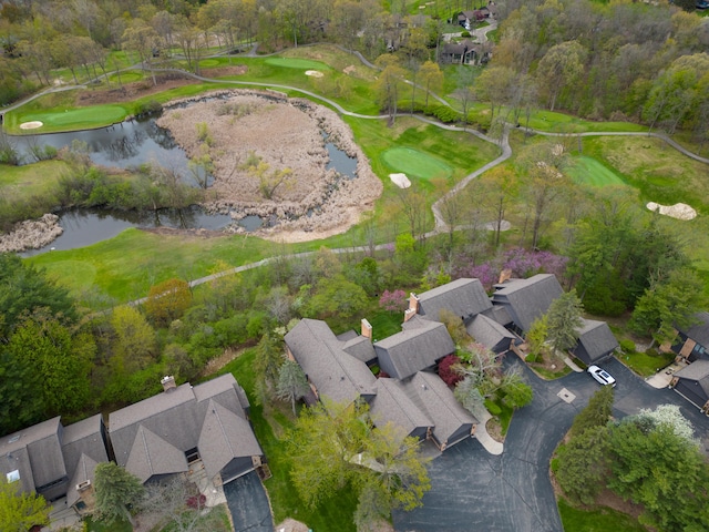 birds eye view of property with view of golf course, a water view, and a residential view