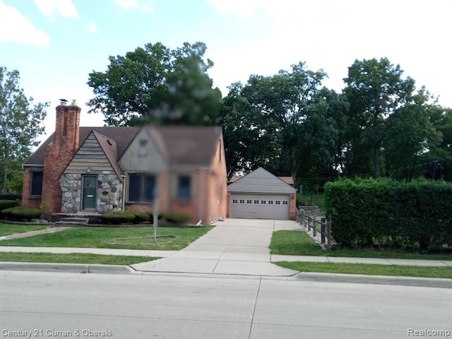 23211 Myrtle St, Dearborn, MI 48128 - view of front facade with a chimney, stone siding, a front yard, and a detached garage