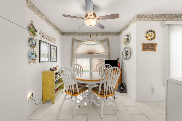 dining area featuring a textured ceiling, baseboards, and a ceiling fan