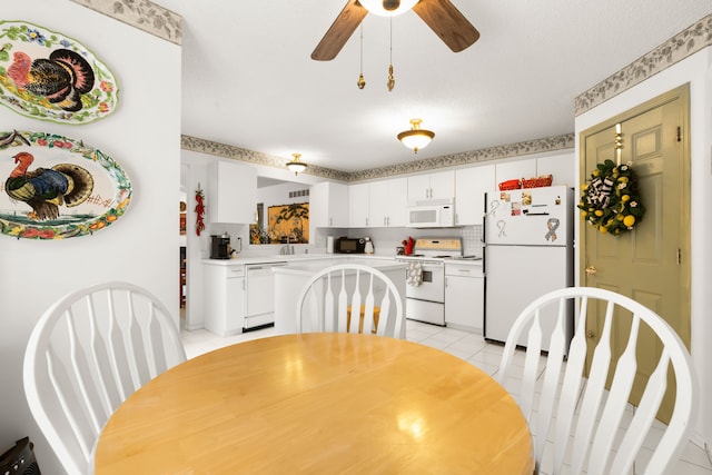 dining space featuring light tile patterned flooring and ceiling fan