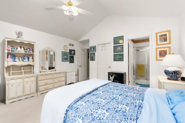 bedroom featuring lofted ceiling, ensuite bath, ceiling fan, visible vents, and light carpet