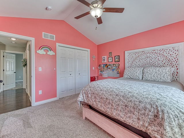 carpeted bedroom with a ceiling fan, a closet, visible vents, baseboards, and lofted ceiling