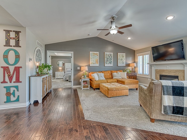 living room with baseboards, lofted ceiling, dark wood finished floors, and ceiling fan