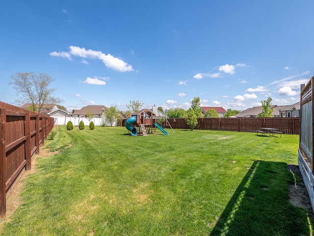 view of yard with a playground and a fenced backyard