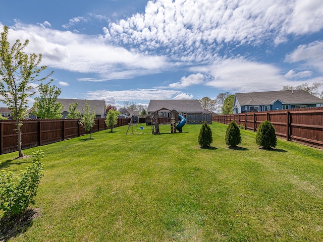 view of yard with a playground and a fenced backyard