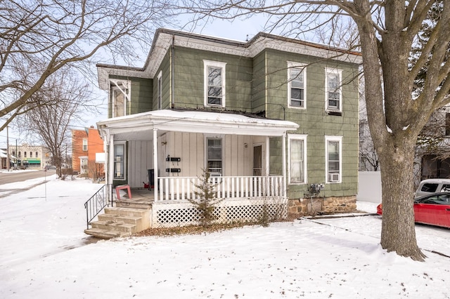124 S Ottawa St, Tecumseh, MI 49286 - view of front of house featuring board and batten siding and a porch