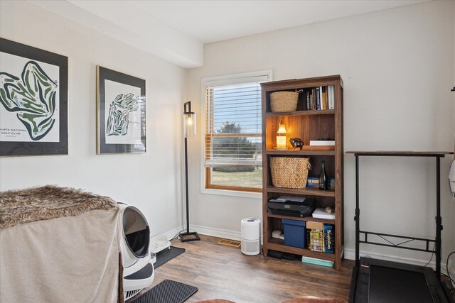 interior space with baseboards and wood finished floors