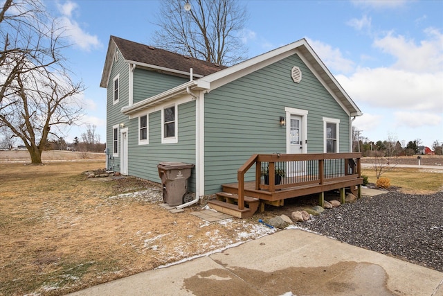 rear view of house featuring a deck