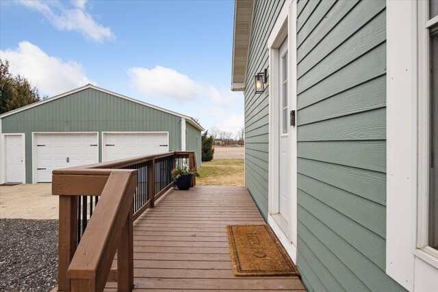 deck with an outdoor structure and a detached garage