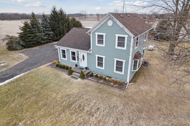 traditional home with a shingled roof
