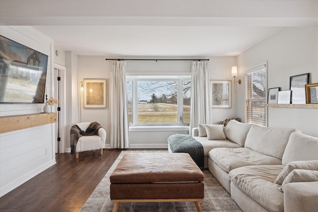 living room featuring baseboards, plenty of natural light, and dark wood finished floors