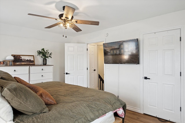 bedroom featuring a ceiling fan and wood finished floors
