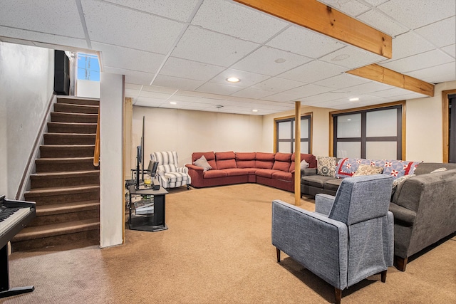carpeted living room featuring stairs, recessed lighting, and a drop ceiling