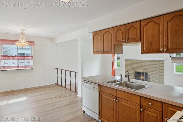 42127 Addison Ave, Canton, MI 48187 - kitchen with white dishwasher, a sink, and brown cabinets