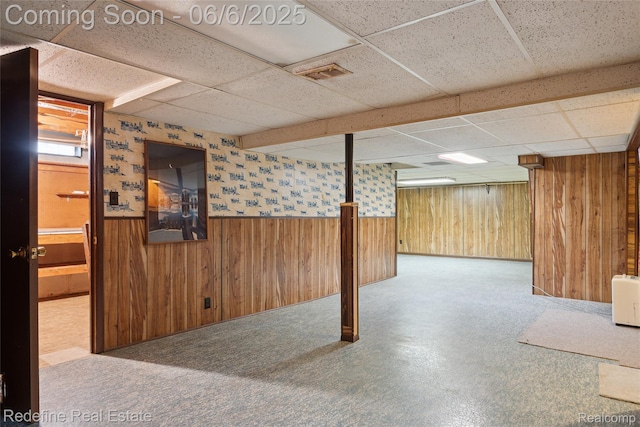 42127 Addison Ave, Canton, MI 48187 - basement with wooden walls, a drop ceiling, and a wainscoted wall
