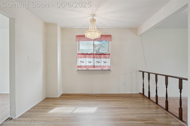 42127 Addison Ave, Canton, MI 48187 - corridor featuring a chandelier, wood finished floors, and baseboards