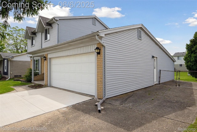 42127 Addison Ave, Canton, MI 48187 - view of side of property featuring brick siding, driveway, and a garage