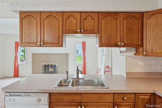 42127 Addison Ave, Canton, MI 48187 - kitchen featuring dishwashing machine, a sink, decorative backsplash, brown cabinets, and light countertops