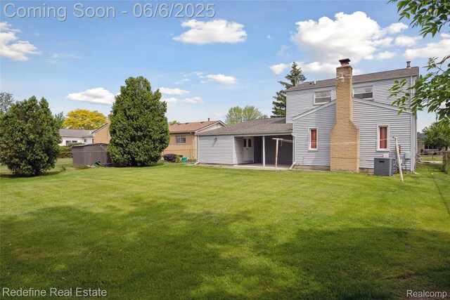 42127 Addison Ave, Canton, MI 48187 - back of property with a patio, a chimney, central AC unit, and a shingled roof