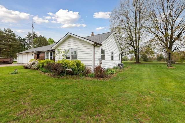 view of property exterior featuring a garage, a chimney, a lawn, concrete driveway, and a shingled roof