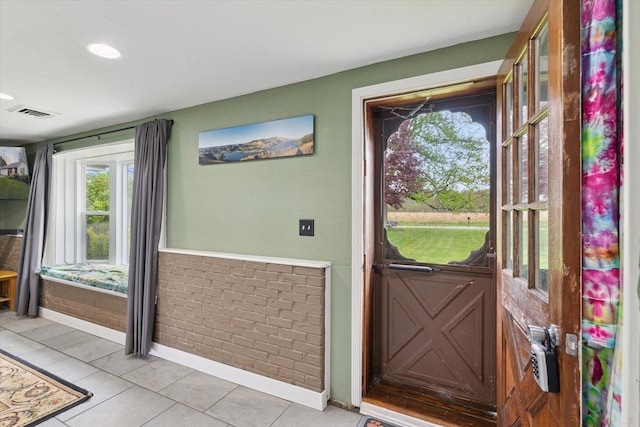 doorway with light tile patterned floors, baseboards, and recessed lighting