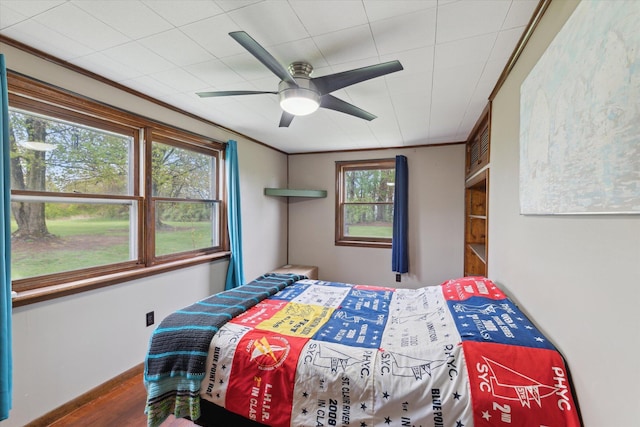bedroom with ceiling fan and wood finished floors