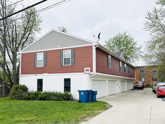 1312 Lafayette Ave, Kalamazoo, MI 49006 - view of side of property with concrete driveway, a yard, and an attached garage